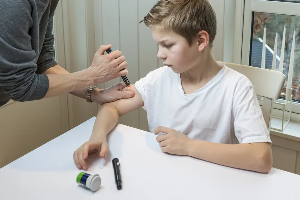 persoana ii face injectie cu insulina unui copil
